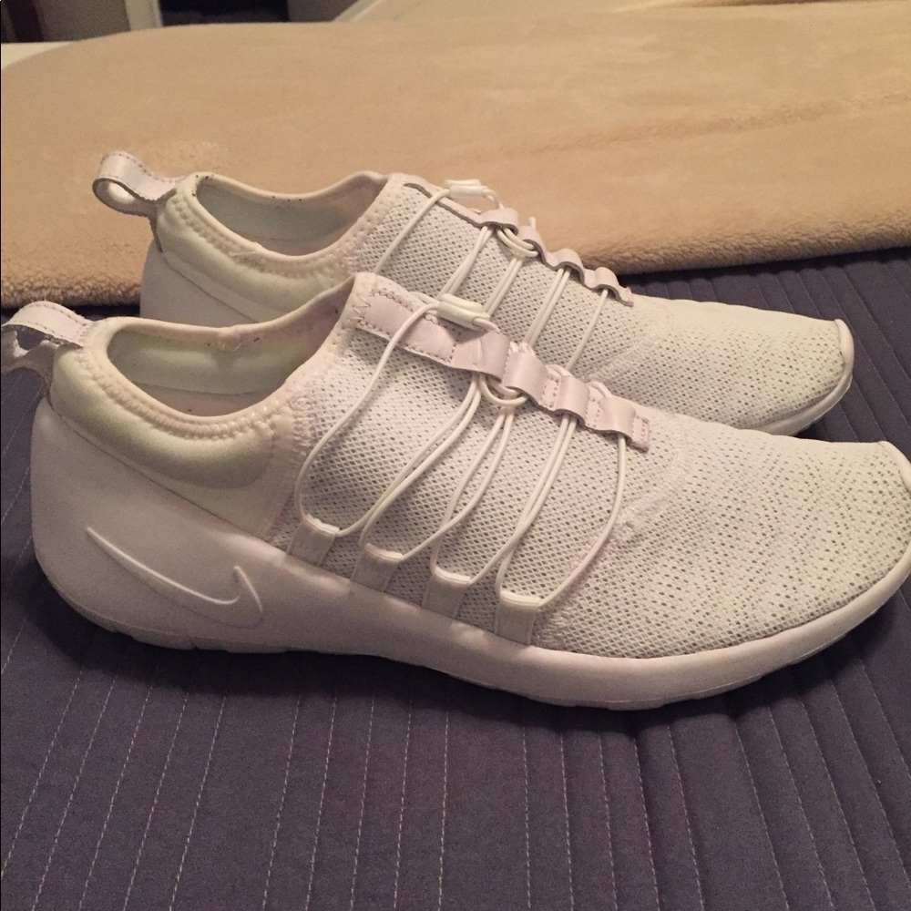 All white Nike slip on sneakers.